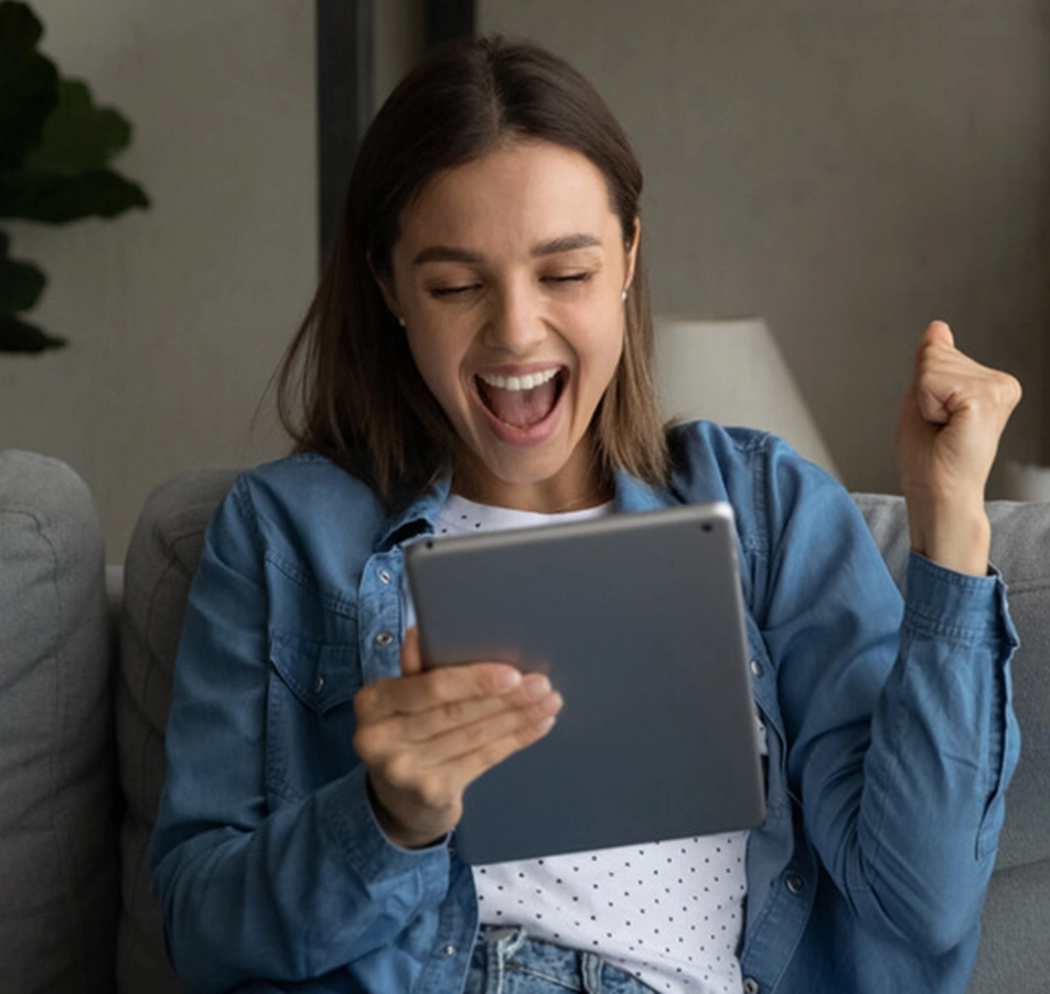 woman cheering at loan accepted on tablet